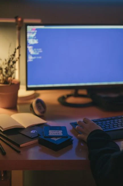 A modern workspace featuring dual computer monitors displaying web design projects, emphasizing technology and productivity.