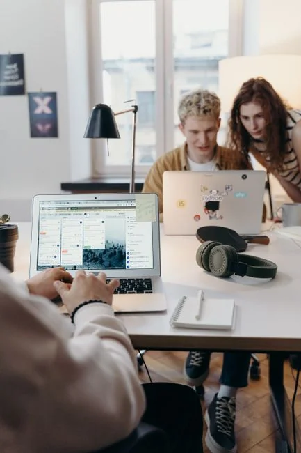 A contemporary computer monitor showing web design projects and creative visuals in a workspace.